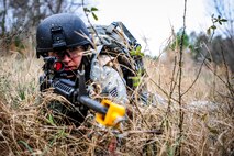 Staff Sgt. Sasha Navarro, 1st Combat Camera Squadron broadcaster, takes cover from  enemy forces during the Ability to Survive and Operate exercise Jan. 16, 2013, at North Auxiliary Air Field, S.C. Combat Camera held the exercise to train Airmen to function outside the wire as combat documentation specialists. The week-long exercise began Jan. 7, 2013, and ended Jan. 18. The 1st CTCS acquires still and motion imagery in support of classified and unclassified air, sea and ground military operations. (U.S. Air Force photo/Senior Airman Dennis Sloan)