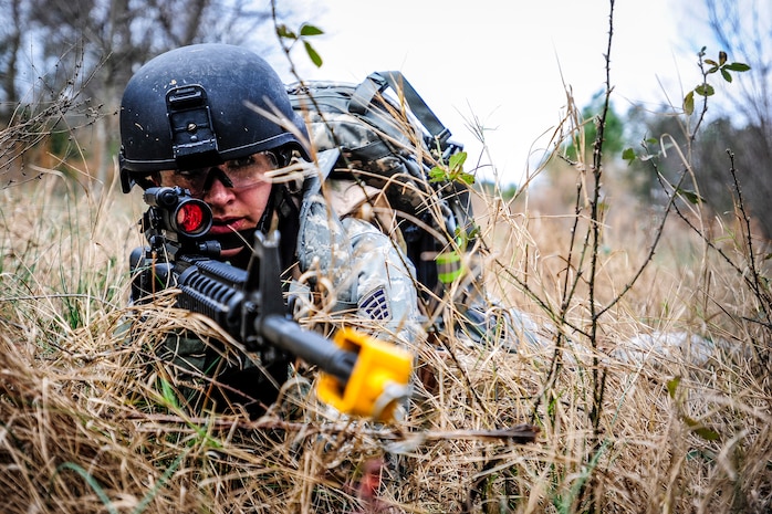 Staff Sgt. Sasha Navarro, 1st Combat Camera Squadron broadcaster, takes cover from  enemy forces during the Ability to Survive and Operate exercise Jan. 16, 2013, at North Auxiliary Air Field, S.C. Combat Camera held the exercise to train Airmen to function outside the wire as combat documentation specialists. The week-long exercise began Jan. 7, 2013, and ended Jan. 18. The 1st CTCS acquires still and motion imagery in support of classified and unclassified air, sea and ground military operations. (U.S. Air Force photo/Senior Airman Dennis Sloan)