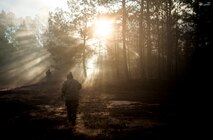 Airmen from the 1st Combat Camera Squadron pose as opposing forces as they prepare to ambush a convoy during the Ability to Survive and Operate exercise Jan. 18, 2013, at North Auxiliary Air Field, S.C. Combat Camera held the exercise to train Airmen to function outside the wire as combat documentation specialists. The week-long exercise began Jan. 7 and ended Jan. 18. The 1st CTCS acquires still and motion imagery in support of classified and unclassified air, sea and ground military operations. (U.S. Air Force photo/Senior Airman Dennis Sloan)