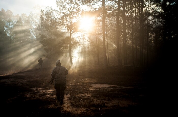 Airmen from the 1st Combat Camera Squadron pose as opposing forces as they prepare to ambush a convoy during the Ability to Survive and Operate exercise Jan. 18, 2013, at North Auxiliary Air Field, S.C. Combat Camera held the exercise to train Airmen to function outside the wire as combat documentation specialists. The week-long exercise began Jan. 7 and ended Jan. 18. The 1st CTCS acquires still and motion imagery in support of classified and unclassified air, sea and ground military operations. (U.S. Air Force photo/Senior Airman Dennis Sloan)