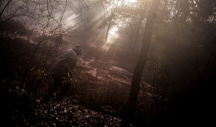 Airmen from the 1st Combat Camera Squadron pose as opposing forces as they prepare to ambush a convoy during the Ability to Survive and Operate exercise Jan. 18, 2013, at North Auxiliary Air Field, S.C. Combat Camera held the exercise to train Airmen to function outside the wire as combat documentation specialists. The week-long exercise began Jan. 7 and ended Jan. 18. The 1st CTCS acquires still and motion imagery in support of classified and unclassified air, sea and ground military operations. (U.S. Air Force photo/Senior Airman Dennis Sloan)