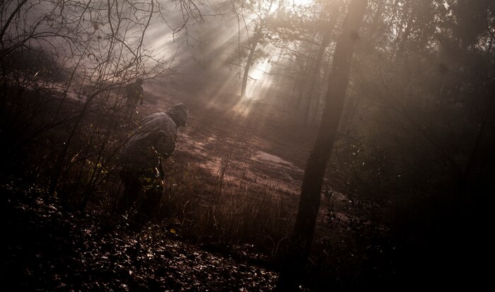 Airmen from the 1st Combat Camera Squadron pose as opposing forces as they prepare to ambush a convoy during the Ability to Survive and Operate exercise Jan. 18, 2013, at North Auxiliary Air Field, S.C. Combat Camera held the exercise to train Airmen to function outside the wire as combat documentation specialists. The week-long exercise began Jan. 7 and ended Jan. 18. The 1st CTCS acquires still and motion imagery in support of classified and unclassified air, sea and ground military operations. (U.S. Air Force photo/Senior Airman Dennis Sloan)