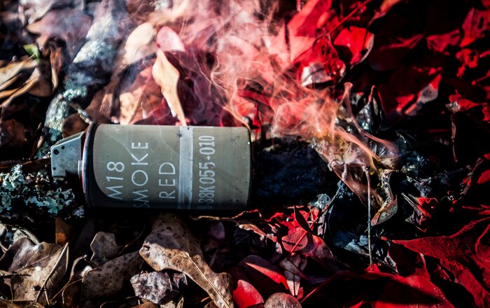 An expended M18 Smoke grenade lies on the ground during the Ability to Survive and Operate exercise Jan. 18, 2013, at North Auxiliary Air Field, S.C. Combat Camera held the exercise to train Airmen to function outside the wire as combat documentation specialists. The week-long exercise began Jan. 7 and ended Jan. 18. The 1st CTCS acquires still and motion imagery in support of classified and unclassified air, sea and ground military operations. (U.S. Air Force photo/Senior Airman Dennis Sloan)