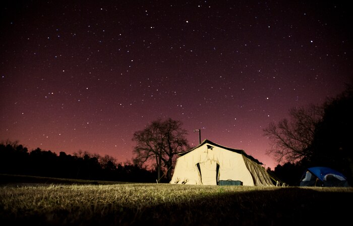 Instructors sleep at a base camp a few miles from the Airmen who are in the field training during the Ability to Survive and Operate exercise Jan. 18, 2013, at North Auxiliary Air Field, S.C. Combat Camera held the exercise to train Airmen to function outside the wire as combat documentation specialists. The week-long exercise began Jan. 7 and ended Jan. 18. The 1st CTCS acquires still and motion imagery in support of classified and unclassified air, sea and ground military operations. (U.S. Air Force photo/Senior Airman Dennis Sloan)