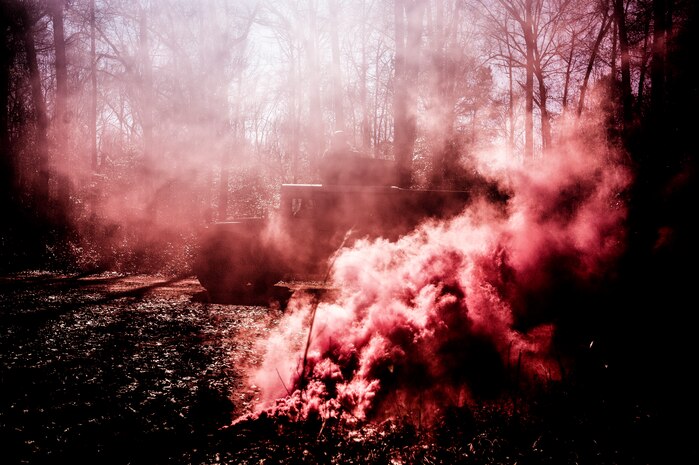 A Humvee drives through an ambush during the Ability to Survive and Operate exercise Jan. 18, 2013, at North Auxiliary Air Field, S.C. Combat Camera held the exercise to train Airmen to function outside the wire as combat documentation specialists. The week-long exercise began Jan. 7 and ended Jan. 18. The 1st CTCS acquires still and motion imagery in support of classified and unclassified air, sea and ground military operations. (U.S. Air Force photo/Senior Airman Dennis Sloan)