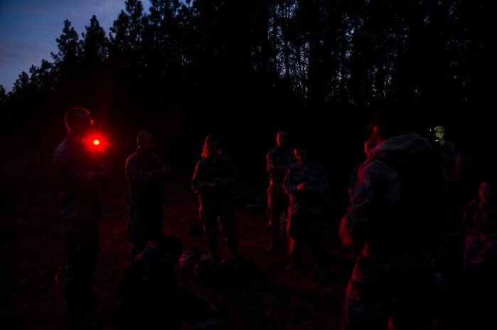 Airmen from the 1st Combat Camera Squadron prepare for a night patrol during the Ability to Survive and Operate exercise Jan. 16, 2013, at North Auxiliary Air Field, S.C. Combat Camera held the exercise to train Airmen to function outside the wire as combat documentation specialists. The week-long exercise began Jan. 7 and ended Jan. 18. The 1st CTCS acquires still and motion imagery in support of classified and unclassified air, sea and ground military operations. (U.S. Air Force photo/Senior Airman George Goslin)