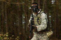 Senior Airman Matthew Bruch, 1st Combat Camera Squadron photographer, runs toward the close quarters battle training building during the Ability to Survive and Operate exercise Jan. 16, 2013, at North Auxiliary Air Field, S.C. Combat Camera held the exercise to train Airmen to function outside the wire as combat documentation specialists. The week-long exercise began Jan. 7, 2013, and ended Jan. 18. The 1st CTCS acquires still and motion imagery in support of classified and unclassified air, sea and ground military operations. (U.S. Air Force photo/Senior Airman George Goslin)