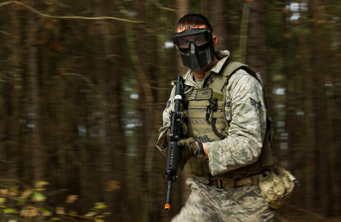 Senior Airman Matthew Bruch, 1st Combat Camera Squadron photographer, runs toward the close quarters battle training building during the Ability to Survive and Operate exercise Jan. 16, 2013, at North Auxiliary Air Field, S.C. Combat Camera held the exercise to train Airmen to function outside the wire as combat documentation specialists. The week-long exercise began Jan. 7, 2013, and ended Jan. 18. The 1st CTCS acquires still and motion imagery in support of classified and unclassified air, sea and ground military operations. (U.S. Air Force photo/Senior Airman George Goslin)