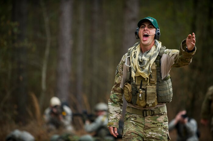 Staff Sgt. Greg Biondo, 1st Combat Camera Squadron photographer, shouts directions to Airmen during the Ability to Survive and Operate exercise Jan. 16, 2013, at North Auxiliary Air Field, S.C. Combat Camera held the exercise to train Airmen to function outside the wire as combat documentation specialists. The week-long exercise began Jan. 7 and ended Jan. 18. The 1st CTCS acquires still and motion imagery in support of classified and unclassified air, sea and ground military operations. (U.S. Air Force photo/Senior Airman George Goslin)