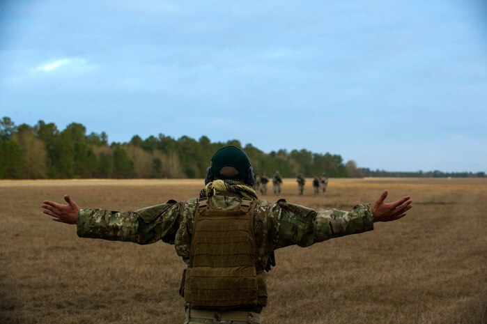 Staff Sgt. Jonathan Lovelady, 1st Combat Camera Squadron photographer, shouts orders at Airmen during the Ability to Survive and Operate exercise Jan. 16, 2013, at North Auxiliary Air Field, S.C. Combat Camera held the exercise to train Airmen to function outside the wire as combat documentation specialists. The week-long exercise began Jan. 7 and ended Jan. 18. The 1st CTCS acquires still and motion imagery in support of classified and unclassified air, sea and ground military operations. (U.S. Air Force photo/Senior Airman George Goslin)