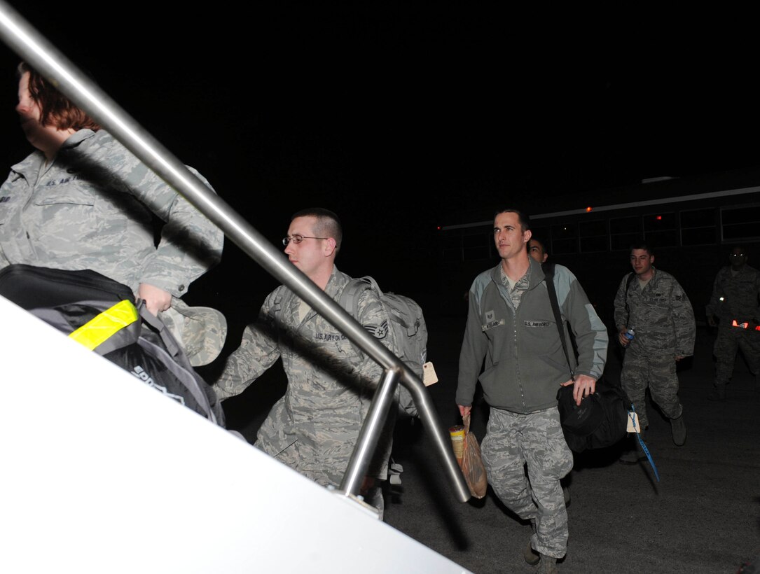 Ellsworth Airmen board an aircraft to deploy at Ellsworth Air Force Base, S.D., Jan. 19, 2013. Approximately 350 Airmen deployed to Southwest Asia to conduct a wide range of tasks to ensure the success of providing critical, long-range capability in the region. (U.S. Air Force photo by Airman 1st Class Anania Tekurio/Released)