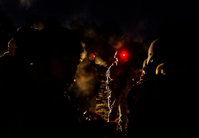 Airmen prepare for a morning patrol during the Ability to Survive and Operate exercise Jan. 18, 2013, at North Auxiliary Air Field, S.C. Combat Camera held the exercise to train Airmen to function outside the wire as combat documentation specialists. The week-long exercise began Jan. 7 and ended Jan. 18. The 1st CTCS acquires still and motion imagery in support of classified and unclassified air, sea and ground military operations. (U.S. Air Force photo/Senior Airman George Goslin)