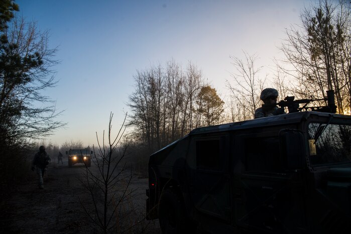 A convoy of Airmen from the 1st Combat Camera Squadron stop at a checkpoint during the Ability to Survive and Operate exercise Jan. 18, 2013, at North Auxiliary Air Field, S.C. Combat Camera held the exercise to train Airmen to function outside the wire as combat documentation specialists. The week-long exercise began Jan. 7 and ended Jan. 18. The 1st CTCS acquires still and motion imagery in support of classified and unclassified air, sea and ground military operations. (U.S. Air Force photo/Senior Airman George Goslin)