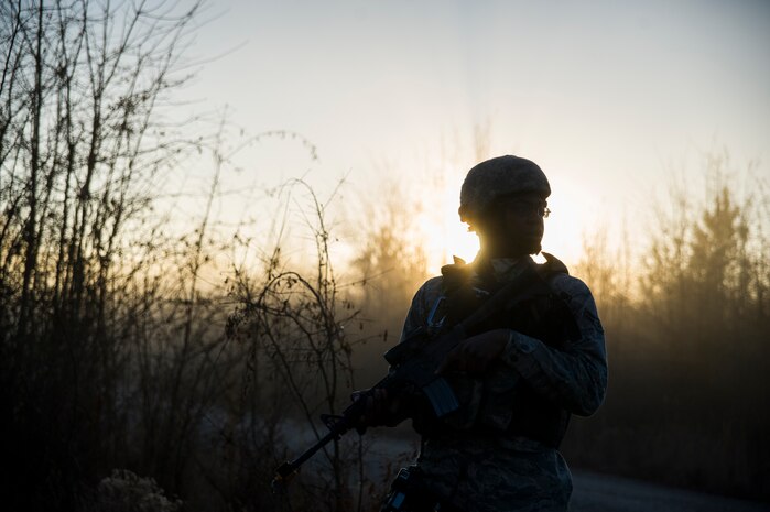Airman 1st Class Tre Gibbs, 1st Combat Camera Squadron photographer, provides security during the Ability to Survive and Operate exercise Jan. 18, 2013, at North Auxiliary Air Field, S.C. Combat Camera held the exercise to train Airmen to function outside the wire as combat documentation specialists. The week-long exercise began Jan. 7 and ended Jan. 18. The 1st CTCS acquires still and motion imagery in support of classified and unclassified air, sea and ground military operations. (U.S. Air Force photo/Senior Airman George Goslin)