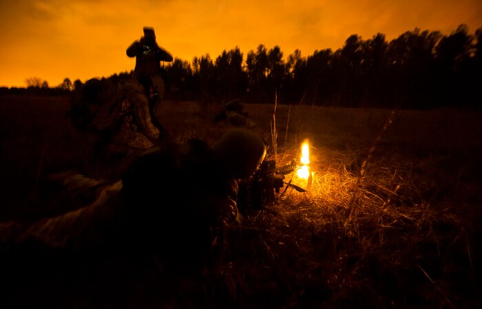 Senior Airman Jodi Martinez, 1st Combat Camera Squadron photographer, fires at opposing forces during the Ability to Survive and Operate exercise Jan. 16, 2013, at North Auxiliary Air Field, S.C. Combat Camera held the exercise to train Airmen to function outside the wire as combat documentation specialists. The week-long exercise began Jan. 7 and ended Jan. 18. The 1st CTCS acquires still and motion imagery in support of classified and unclassified air, sea and ground military operations. (U.S. Air Force photo/Senior Airman George Goslin)