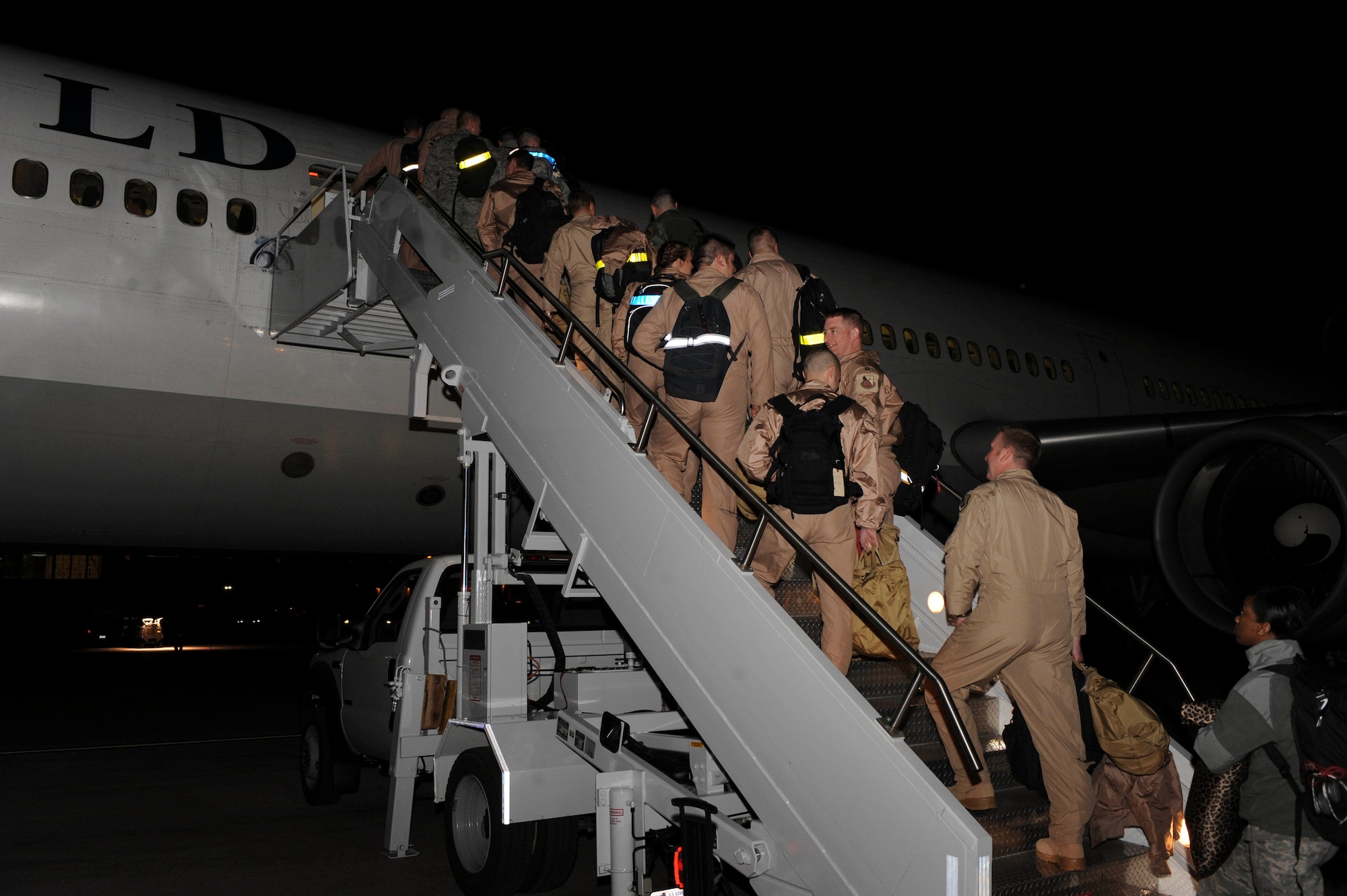 Ellsworth Airmen board an aircraft set for deployment at Ellsworth Air Force Base, S.D., Jan. 19, 2013. The Airmen deployed to Southwest Asia to prepare and launch B-1 missions in support of national military objectives in the U.S. Central Command Area of Responsibility. (U.S. Air Force photo by Airman 1st Class Anania Tekurio/Released)