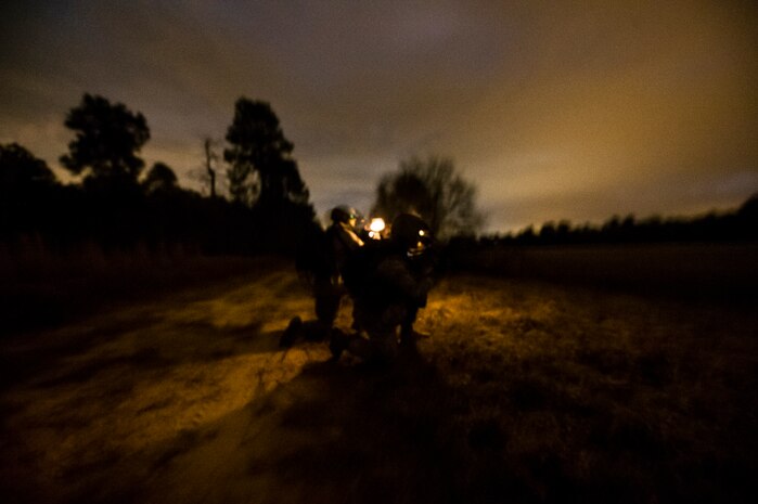 Airmen from the 1st Combat Camera Squadron fire at opposing forces during the Ability to Survive and Operate exercise Jan. 16, 2013, at North Auxiliary Air Field, S.C. Combat Camera held the exercise to train Airmen to function outside the wire as combat documentation specialists. The week-long exercise began Jan. 7 and ended Jan. 18. The 1st CTCS acquires still and motion imagery in support of classified and unclassified air, sea and ground military operations. (U.S. Air Force photo/Senior Airman George Goslin)