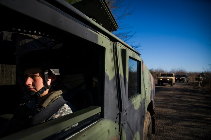Staff Sgt. Ashley Hyatt, 1st Combat Camera Squadron photographer, waits in the driver's seat of the Humvee while waiting at a checkpoint during the Ability to Survive and Operate exercise Jan. 18, 2013, at North Auxiliary Air Field, S.C. Combat Camera held the exercise to train Airmen to function outside the wire as combat documentation specialists. The week-long exercise began Jan. 7 and ended Jan. 18. The 1st CTCS acquires still and motion imagery in support of classified and unclassified air, sea and ground military operations. (U.S. Air Force photo/Senior Airman George Goslin)