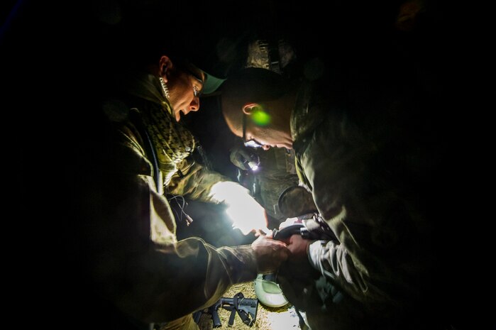 Tech. Sgt. Michael Carlson, 1st Combat Camera Squadron maintainer, repairs night vision goggles for Airmen during the Ability to Survive and Operate exercise Jan. 16, 2013, at North Auxiliary Air Field, S.C. Combat Camera held the exercise to train Airmen to function outside the wire as combat documentation specialists. The week-long exercise began Jan. 7 and ended Jan. 18. The 1st CTCS acquires still and motion imagery in support of classified and unclassified air, sea and ground military operations. (U.S. Air Force photo/Senior Airman George Goslin)