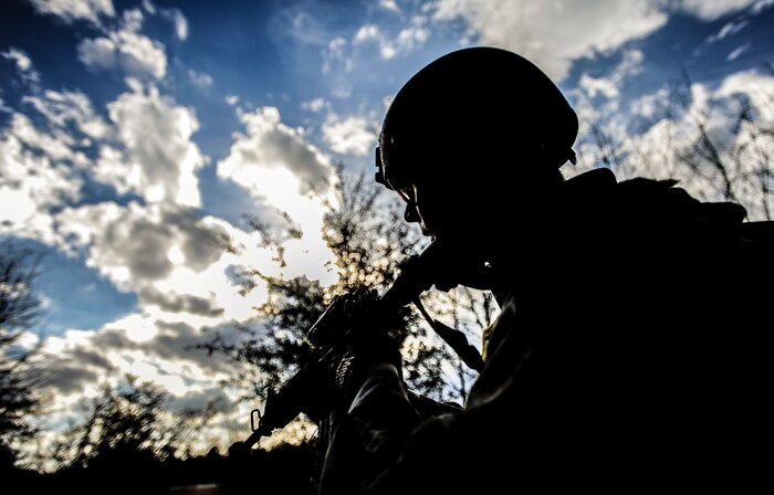 Airman 1st Class Eric Mann, 1st Combat Camera Squadron broadcaster, walks along a road in a team tactical movement patrol during the Ability to Survive and Operate exercise Jan. 16, 2013, at North Auxiliary Air Field, S.C. Combat Camera held the exercise to train Airmen to function outside the wire as combat documentation specialists. The week-long exercise began Jan. 7 and ended Jan. 18. The 1st CTCS acquires still and motion imagery in support of classified and unclassified air, sea and ground military operations. (U.S. Air Force photo/Senior Airman Dennis Sloan)