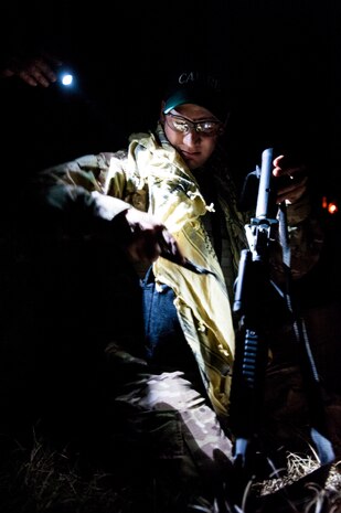 Tech. Sgt. Michael Carlson, 1st Combat Camera Squadron maintainer, checks equipment during the Ability to Survive and Operate exercise Jan. 16, 2013, at North Auxiliary Air Field, S.C. Combat Camera held the exercise to train Airmen to function outside the wire as combat documentation specialists. The week-long exercise began Jan. 7, 2013, and ended Jan. 18. The 1st CTCS acquires still and motion imagery in support of classified and unclassified air, sea and ground military operations.  (U.S. Air Force photo/Senior Airman Dennis Sloan)