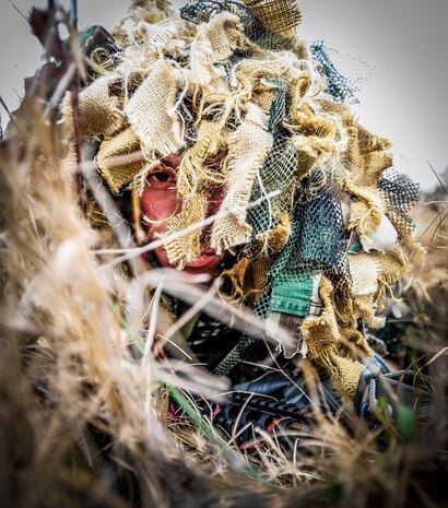 Staff Sgt. Samuel Weaver, 1st Combat Camera Squadron maintainer, waits in the grass for opposing forces role players, during the Ability to Survive and Operate exercise Jan. 16, 2013, at North Auxiliary Air Field, S.C. Combat Camera held the exercise to train Airmen to function outside the wire as combat documentation specialists. The week-long exercise began Jan. 7, 2013, and ended Jan. 18. The 1st CTCS acquires still and motion imagery in support of classified and unclassified air, sea and ground military operations. (U.S. Air Force photo/Senior Airman Dennis Sloan)