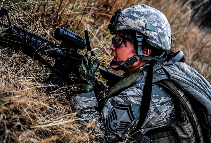 Senior Master Sgt. Elizabeth Carty, 1st Combat Camera Squadron photographer, communicates over the radio during the Ability to Survive and Operate exercise Jan. 16, 2013, at North Auxiliary Air Field, S.C. Combat Camera held the exercise to train Airmen to function outside the wire as combat documentation specialists. The week-long exercise began Jan. 7, 2013, and ended Jan. 18. The 1st CTCS acquires still and motion imagery in support of classified and unclassified air, sea and ground military operations. (U.S. Air Force photo/Senior Airman Dennis Sloan)