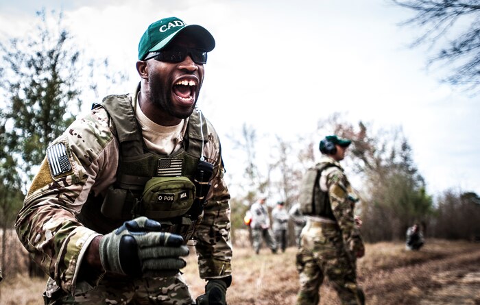 Tech. Sgt. DeNoris Mickle, 1st Combat Camera Squadron photo element lead shouts orders to Airmen during the Ability to Survive and Operate exercise Jan. 16, 2013, at North Auxiliary Air Field, S.C. Combat Camera held the exercise to train Airmen to function outside the wire as combat documentation specialists. The week-long exercise began Jan. 7 and ended Jan. 18. The 1st CTCS acquires still and motion imagery in support of classified and unclassified air, sea and ground military operations. (U.S. Air Force photo/Senior Airman Dennis Sloan)