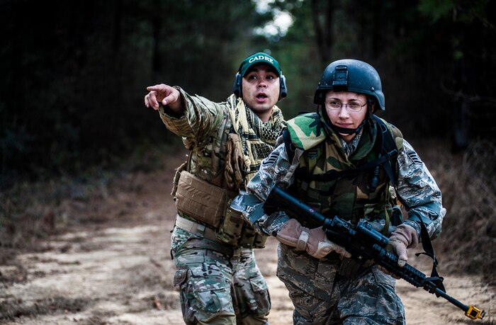 Staff Sgt. Jon Lovelady, 1st Combat Camera Squadron photographer, gives orders to Staff Sgt. Michelle Demers, 1st CTCS broadcaster, during the Ability to Survive and Operate exercise Jan. 16, 2013, at North Auxiliary Air Field, S.C. Combat Camera held the exercise to train Airmen to function outside the wire as combat documentation specialists. The week-long exercise began Jan. 7 and ended Jan. 18. The 1st CTCS acquires still and motion imagery in support of classified and unclassified air, sea and ground military operations. (U.S. Air Force photo/Senior Airman Dennis Sloan)