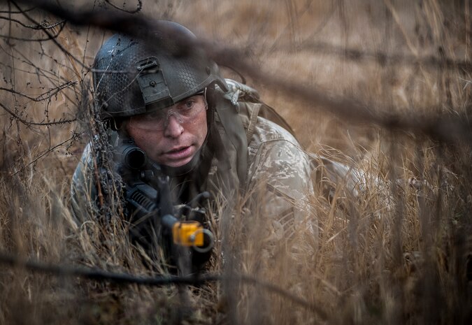 Master Sgt. Justin Sudith, 1st Combat Camera Squadron broadcaster, takes cover against opposing forces role players during the Ability to Survive and Operate exercise Jan. 16, 2013, at North Auxiliary Air Field, S.C. Combat Camera held the exercise to train Airmen to function outside the wire as combat documentation specialists. The week-long exercise began Jan. 7 and ended Jan. 18. The 1st CTCS acquires still and motion imagery in support of classified and unclassified air, sea and ground military operations. (U.S. Air Force photo/Senior Airman Dennis Sloan)