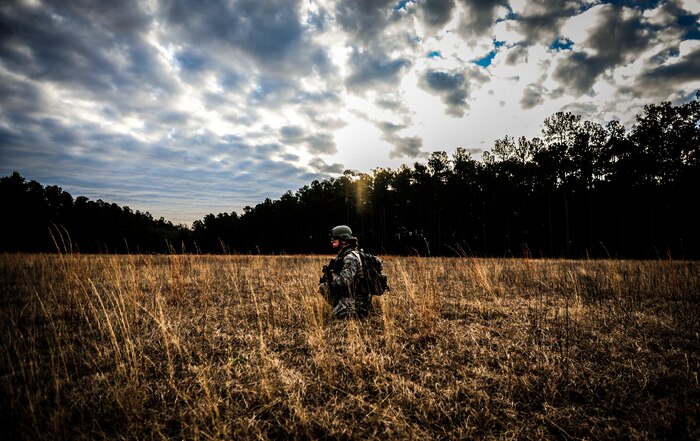 Senior Airman Angela Setliff, 1st Combat Camera Squadron broadcaster, provides rear security of a tactical movement patrol during the Ability to Survive and Operate exercise Jan. 16, 2013, at North Auxiliary Air Field, S.C. Combat Camera held the exercise to train Airmen to function outside the wire as combat documentation specialists. The week-long exercise began Jan. 7 and ended Jan. 18. The 1st CTCS acquires still and motion imagery in support of classified and unclassified air, sea and ground military operations. (U.S. Air Force photo/Senior Airman Dennis Sloan)
