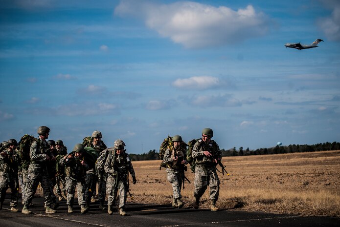Airmen from the 1st Combat Camera Squadron ruck march to their campsite during the Ability to Survive and Operate exercise Jan. 14, 2013, at North Auxiliary Air Field, S.C. Combat Camera held the exercise to train Airmen to function outside the wire as combat documentation specialists. The week-long exercise began Jan. 7 and ended Jan. 18. The 1st CTCS acquires still and motion imagery in support of classified and unclassified air, sea and ground military operations. (U.S. Air Force photo/Senior Airman Dennis Sloan)