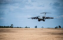 A C-17 Globemaster III lands with Airmen from the 1st Combat Camera Squadron during the Ability to Survive and Operate exercise Jan. 14, 2013, at North Auxiliary Air Field, S.C. The 1st CTCS held the exercise to train Airmen to function outside the wire as combat documentation specialists. The week-long exercise began Jan. 7 and ended Jan. 18. The 1st CTCS acquires still and motion imagery in support of classified and unclassified air, sea and ground military operations. (U.S. Air Force photo/Senior Airman Dennis Sloan)