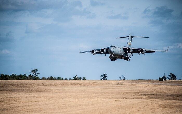 A C-17 Globemaster III lands with Airmen from the 1st Combat Camera Squadron during the Ability to Survive and Operate exercise Jan. 14, 2013, at North Auxiliary Air Field, S.C. The 1st CTCS held the exercise to train Airmen to function outside the wire as combat documentation specialists. The week-long exercise began Jan. 7 and ended Jan. 18. The 1st CTCS acquires still and motion imagery in support of classified and unclassified air, sea and ground military operations. (U.S. Air Force photo/Senior Airman Dennis Sloan)