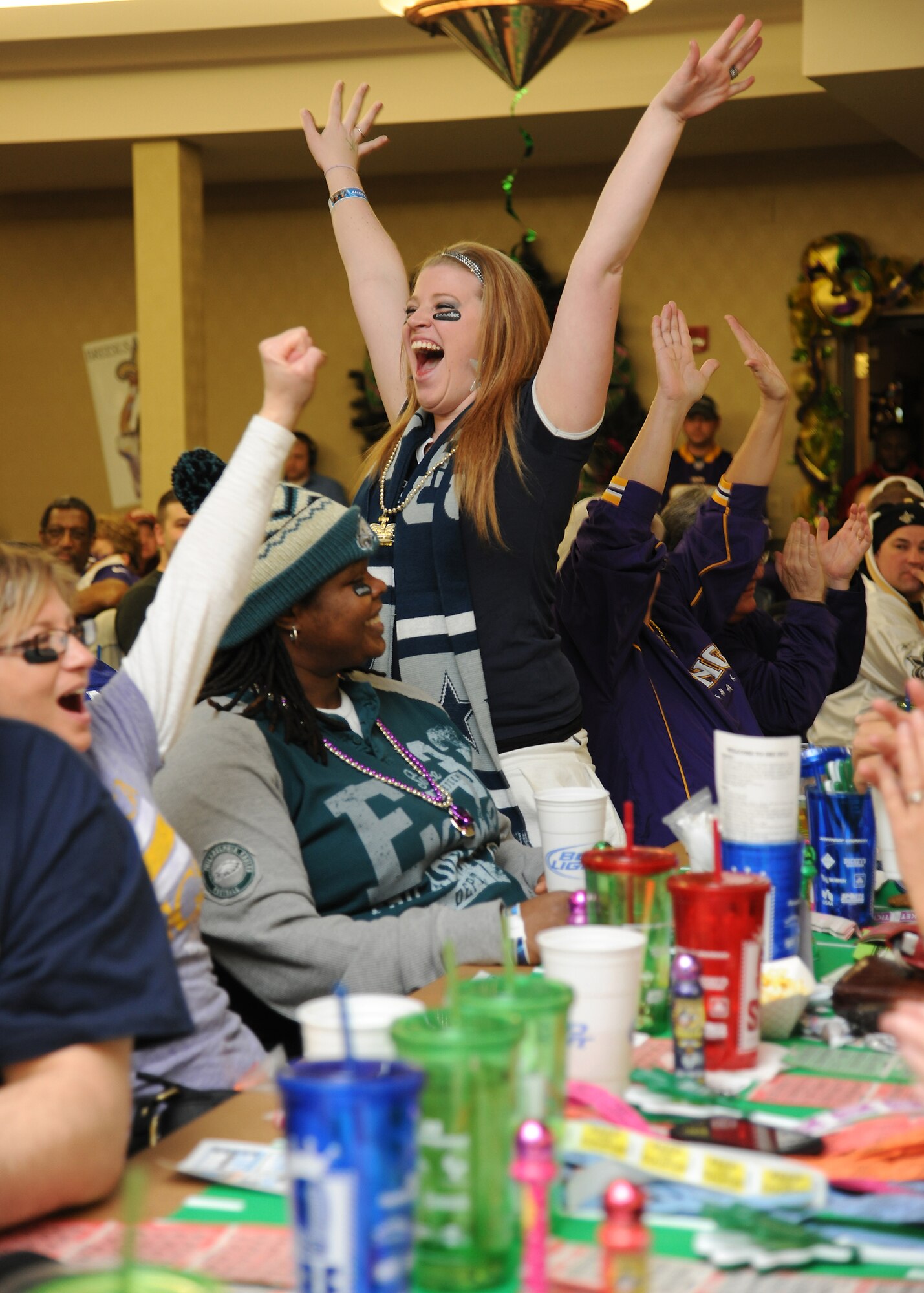 A guest attending the 2013 Super Bowl Extravaganza raises her hands and screams in excitement Jan. 19, 2013, after winning the auction for a helmet football helmet autographed by legendary football quarterback, Roger Staubach, on Grand Forks Air Force Base, N.D. The fun-filled football fan event was co-hosted at the Northern Lights Club and the Base Honor Guard building across the street by using video feeds going to and from each building. (U.S. Air Force photo/Airman 1st Class Xavier Navarro)