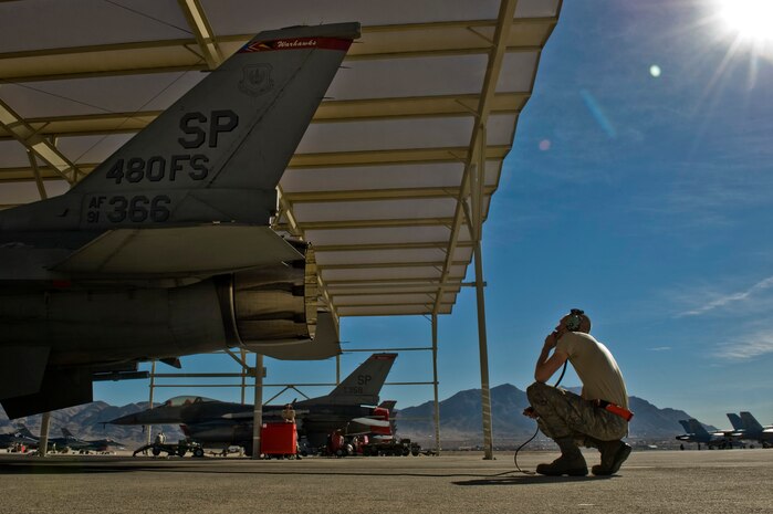 Airman 1st Class Daniel Lasal, 480th Aircraft Maintenance Unit crew chief from Spangdalhem, Air Force Base, Germany, performs preflight checks on an F-16 Fighting Falcon during Red Flag 13-2 Jan. 22, 2013, at Nellis Air Force Base, Nev. Lasal watches the engine and talks to the pilot as he puts the engine though its preflight inspection. (U.S. Air Force Photo by Senior Airman Daniel Hughes)