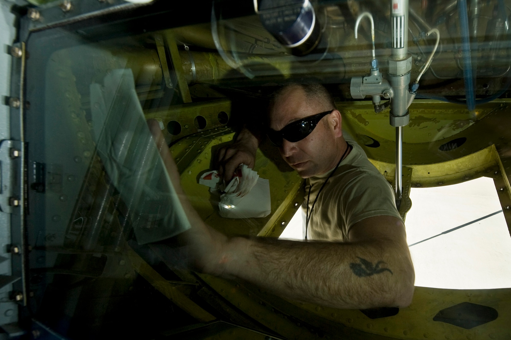 Staff Sgt. Sean Lowery, 22nd Aircraft Maintenance Squadron hydraulics, cleans the boom operator?s window after a refueling mission during Red Flag 13-2 Jan. 22, 2013, at Nellis Air Force Base, Nev. Lowery cleans the window to ensure the boom operator has clear visibility of the boom and refueling jet when he connects during refueling operations. (U.S. Air Force Photo by Senior Airman Daniel Hughes)


