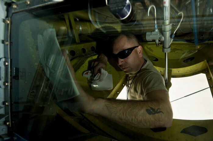Staff Sgt. Sean Lowery, 22nd Aircraft Maintenance Squadron hydraulics, cleans the boom operator?s window after a refueling mission during Red Flag 13-2 Jan. 22, 2013, at Nellis Air Force Base, Nev. Lowery cleans the window to ensure the boom operator has clear visibility of the boom and refueling jet when he connects during refueling operations. (U.S. Air Force Photo by Senior Airman Daniel Hughes)