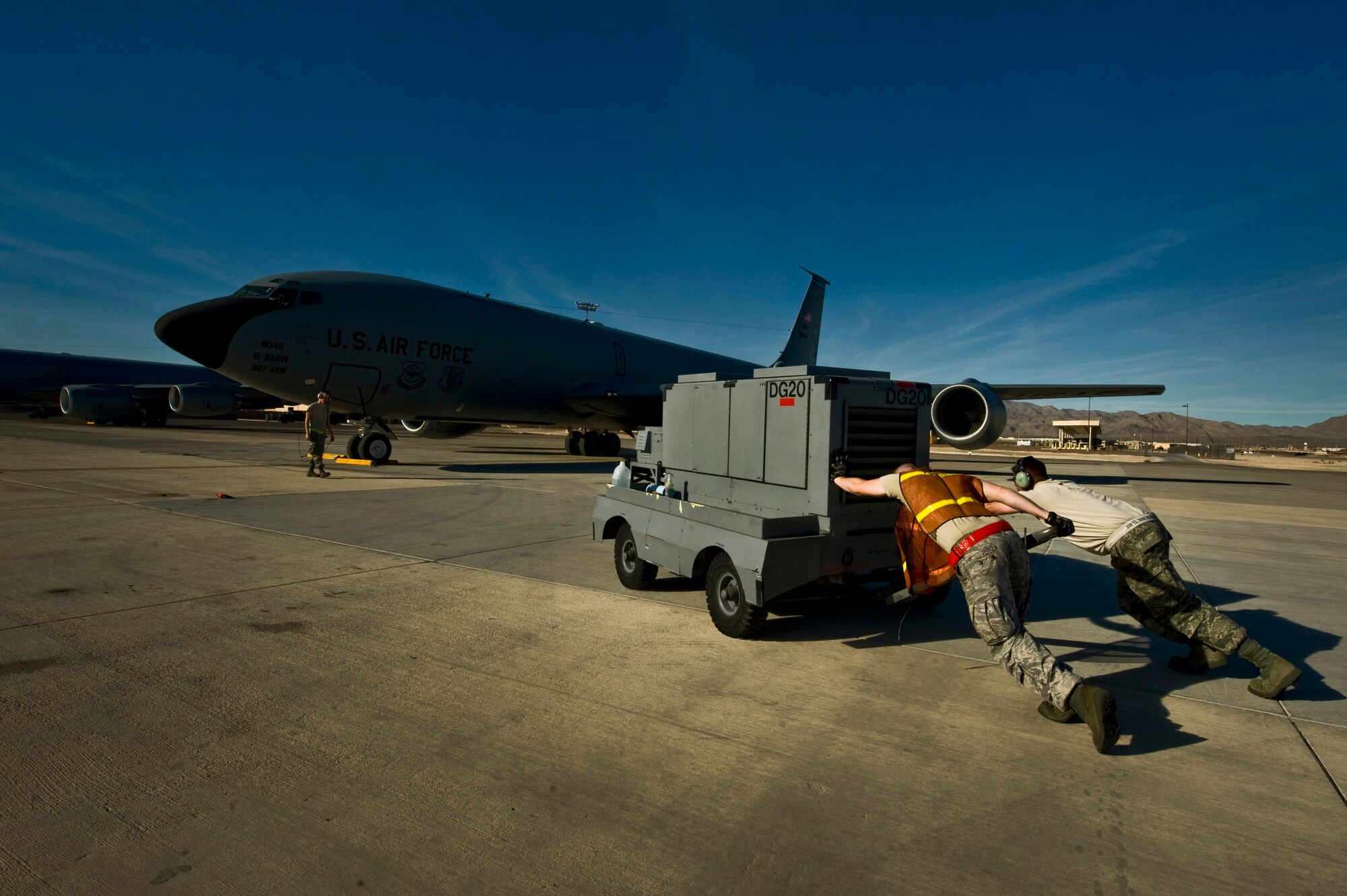 Airmen from McConnell Air Force Base, Kan., push a generator towards a KC-135 Stratotanker during Red Flag 13-2 Jan. 22, 2013, at Nellis Air Force Base, Nev. McConnell Air Force Base is one of only three supertanker KC-135 Stratotanker wings in the Air Force. (U.S. Air Force Photo by Senior Airman Daniel Hughes)


