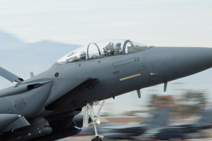 A weapon systems officer displays the "rock on" sign from the cockpit of an F-15E Strike Eagle from Mountain Home Air Force Base, Idaho, during Red Flag 13-2 Jan. 24, 2013, at Nellis Air Force Base, Nev. Units from around the world participate in Red Flag exercises to prepare for real world scenarios. (U.S. Air Force photo by Caitlin Kenney) 
