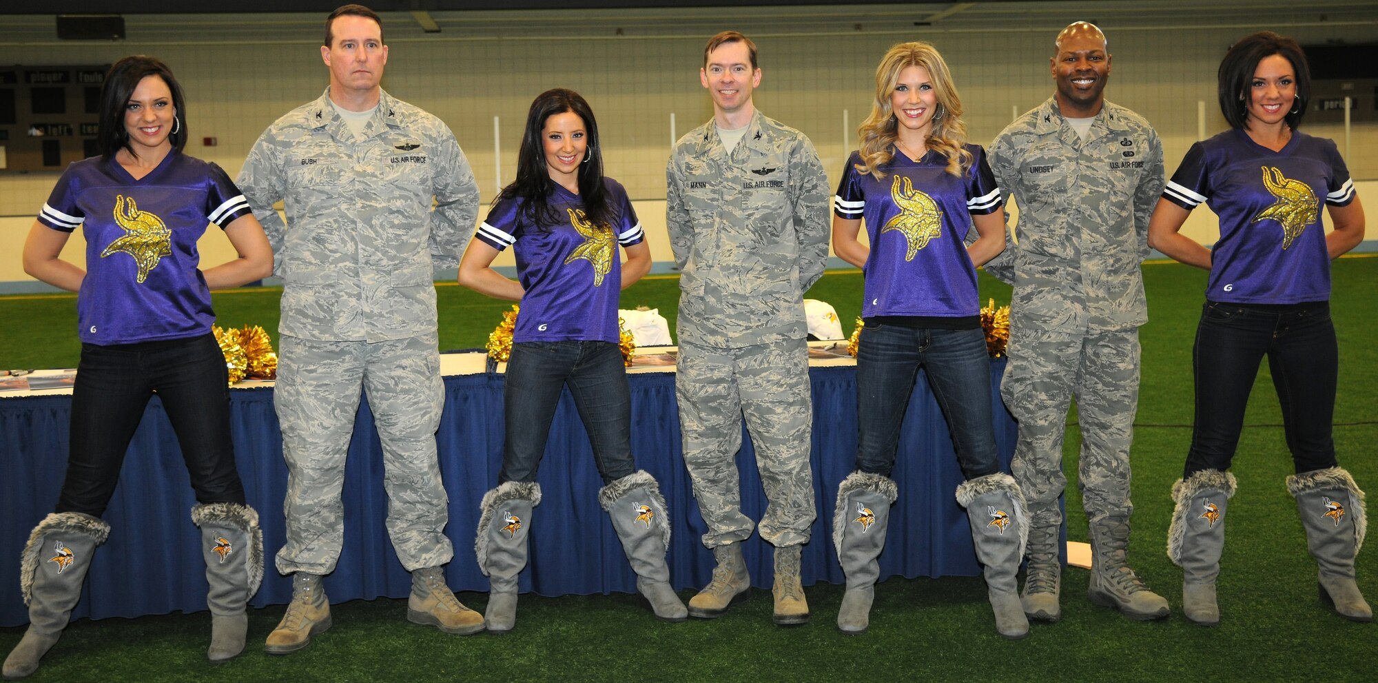 (From left) Col. Tim Bush, 319th Air Base Wing commander, Col. Christopher Mann, 319th Air Base Wing vice commander, and Col. Joe Lindsey, 319th Mission Support Group commander, pose with four members of the Minnesota Vikings cheerleading team Jan. 19, 2013, at the Fitness Center on Grand Forks Air Force Base, N.D. The cheerleaders helped support the 2013 Super Bowl Extravaganza by planning a meet and greet for military members, friends and family. (U.S. Air Force photo/Airman 1st Class Xavier Navarro)