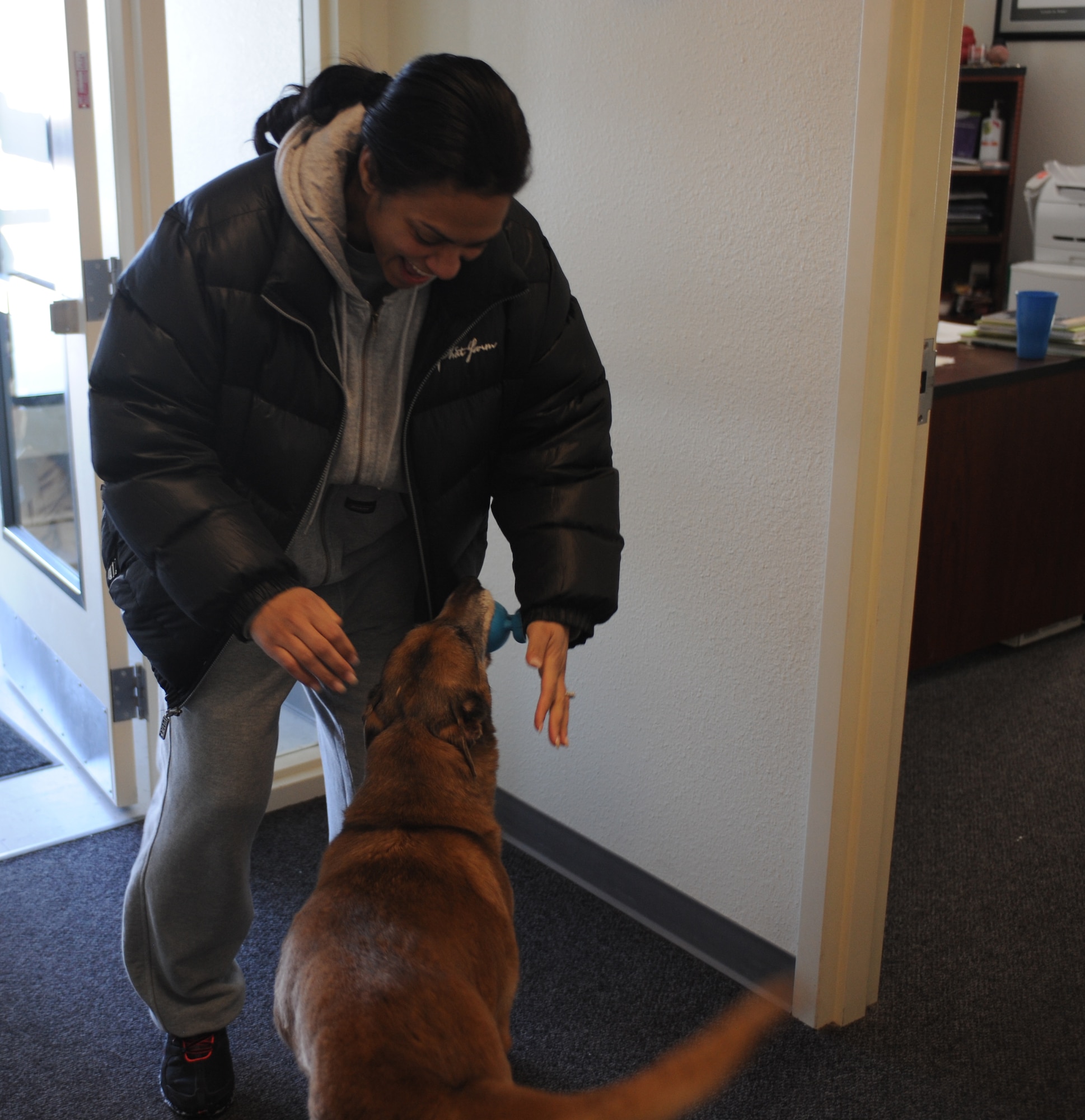 U.S. Air Force Tech. Sgt. Roseann Kelly, 366th Security Forces Squadron assistant flight chief, is welcomed as she walks in the door of the 366th SFS kennels Jan. 18, 2013, by Tanja. Kelly was Tanja's last handler since her retirement and has formally adopted her. (U.S. Air Force photo/Senior Airman Benjamin Sutton) 