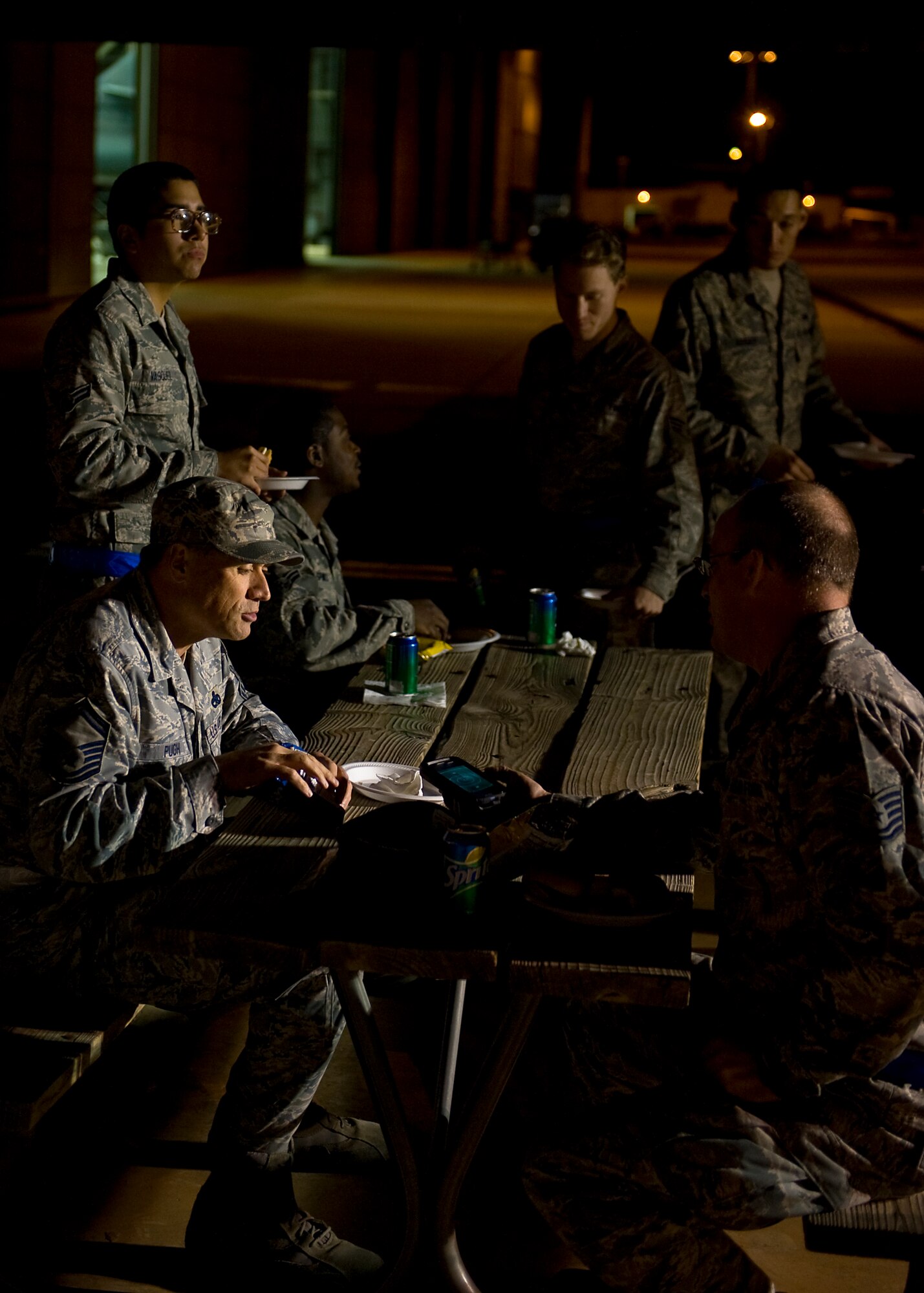 Dyess servicemembers gather outside the 3-Bay Hanger during a midnight barbecue Jan. 24, 2013, at Dyess Air Force Base, Texas. The barbecue was held by the Dyess first sergeant’s group to congratulate swing and mid-shift for personnel on the “Excellent” grade earned during the Consolidated Unit Inspection held Jan. 13-18.(U.S. Air Force photo by Airman 1st Class Damon Kasberg/ Released)