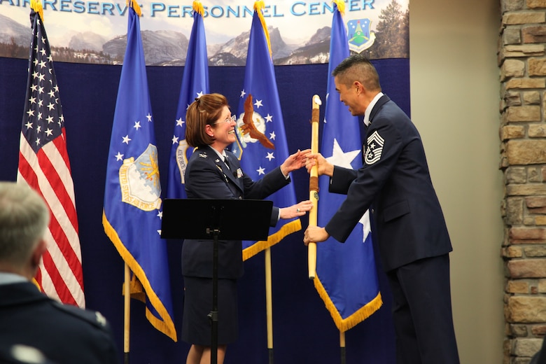 Col. Patricia S. Blassie, outgoing Air Reserve Personnel Center commander, hands the Buckley Air Force Base spirit stick to Chief Master Sgt. Brian Wong, Air Reserve Personnel Center command chief, during the ARPC change of command ceremony held Jan. 25, 2013, on Buckley Air Force Base, Colo. (U.S. Air Force photo/Tech. Sgt. Rob Hazelett)