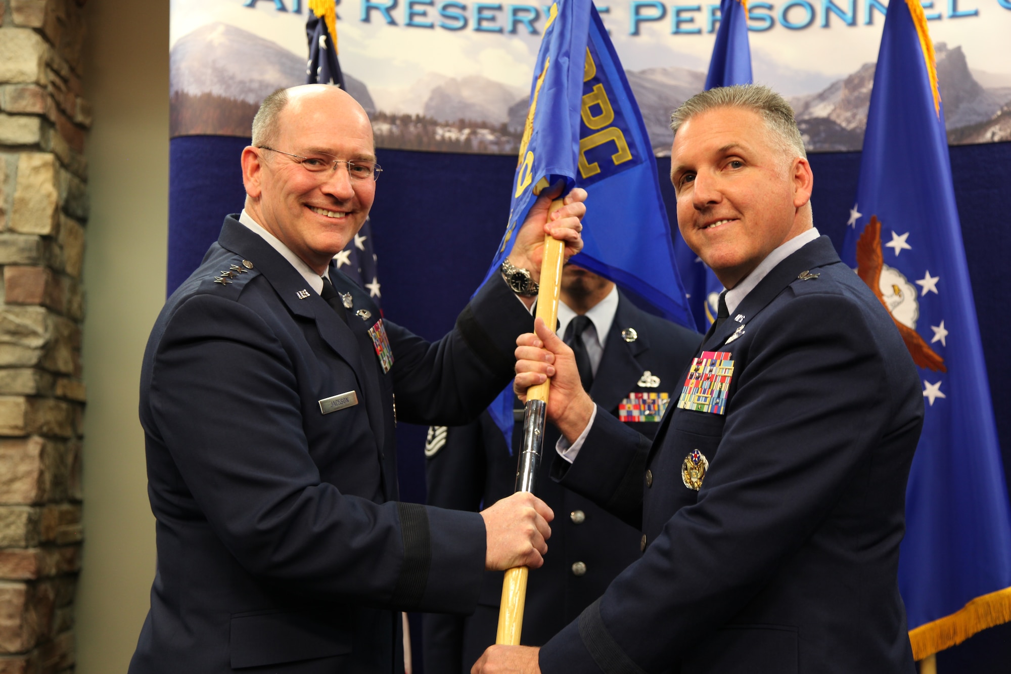 Lt. Gen. James “JJ” Jackson, chief of the Air Force Reserve and commander of the Air Force Reserve Command, passes the Air Reserve Personnel Center guidon to Brig. Gen. John C. Flournoy, Jr., incoming ARPC commander, during a change of command ceremony held Jan. 25, 2013, on Buckley Air Force Base, Colo. General Flournoy was the 349th Air Mobility Wing Commander at Travis AFB, Calif., before assuming command of ARPC. Outgoing commander, Col. Patricia S. Blassie, relinquished command of the center to serve at the Air Force Reserve Command as the chief of the Professional Development Center. (U.S. Air Force photo/Tech. Sgt. Rob Hazelett)