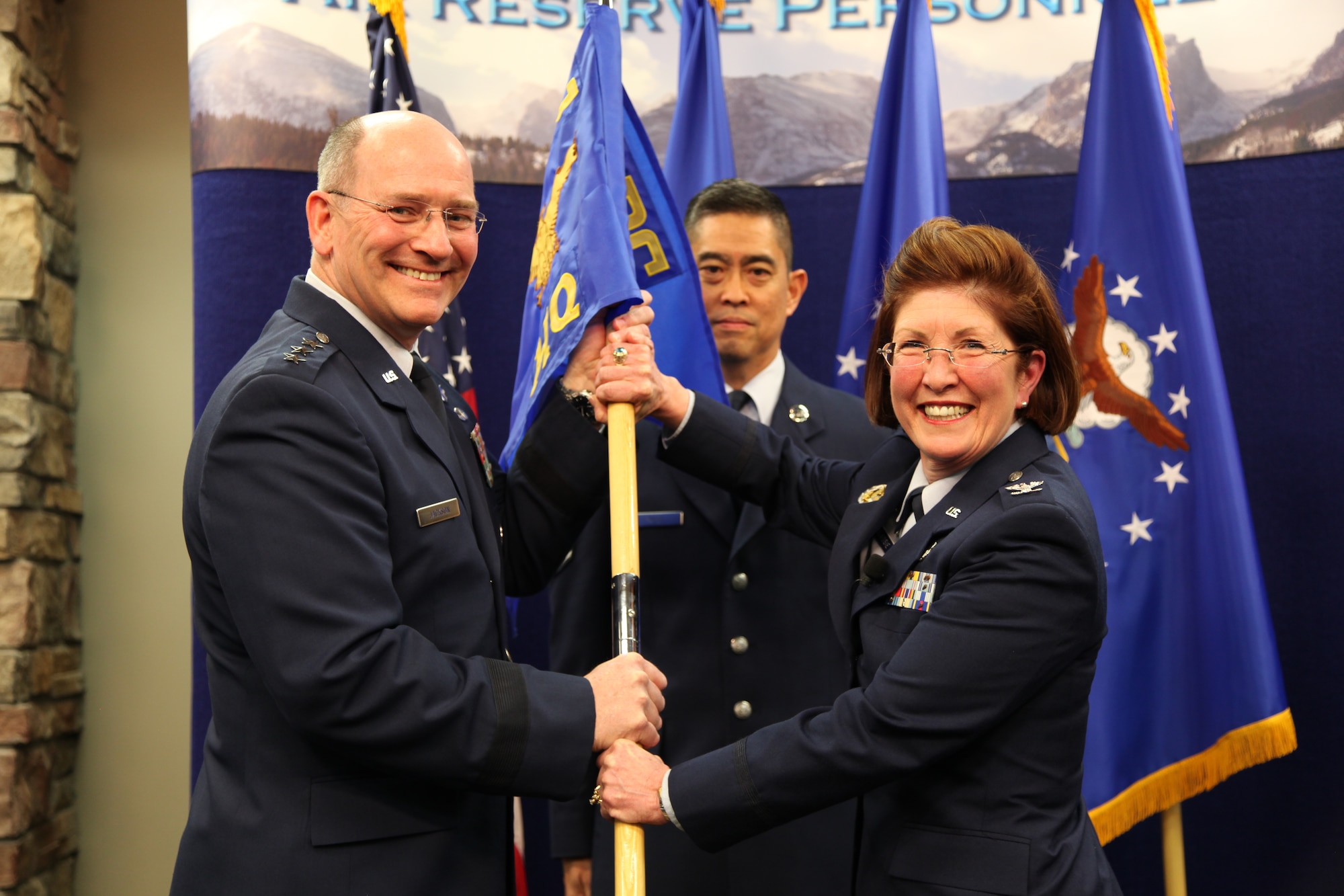 Lt. Gen. James “JJ” Jackson, chief of the Air Force Reserve and commander of the Air Force Reserve Command, takes the Air Reserve Personnel Center guidon from Col. Patricia S. Blassie, outgoing ARPC commander, as Chief Master Sgt. Brian Wong, ARPC command chief, looks on during a change of command ceremony held Jan. 25, 2013, on Buckley Air Force Base, Colo. Blassie will serve at the Air Force Reserve Command as the chief of the Professional Development Center. Incoming ARPC commander, Brig. Gen. John C. Flournoy, Jr, who was the 349th Air Mobility Wing Commander at Travis AFB, Calif., assumed command of the center. (U.S. Air Force photo/Tech. Sgt. Rob Hazelett)
