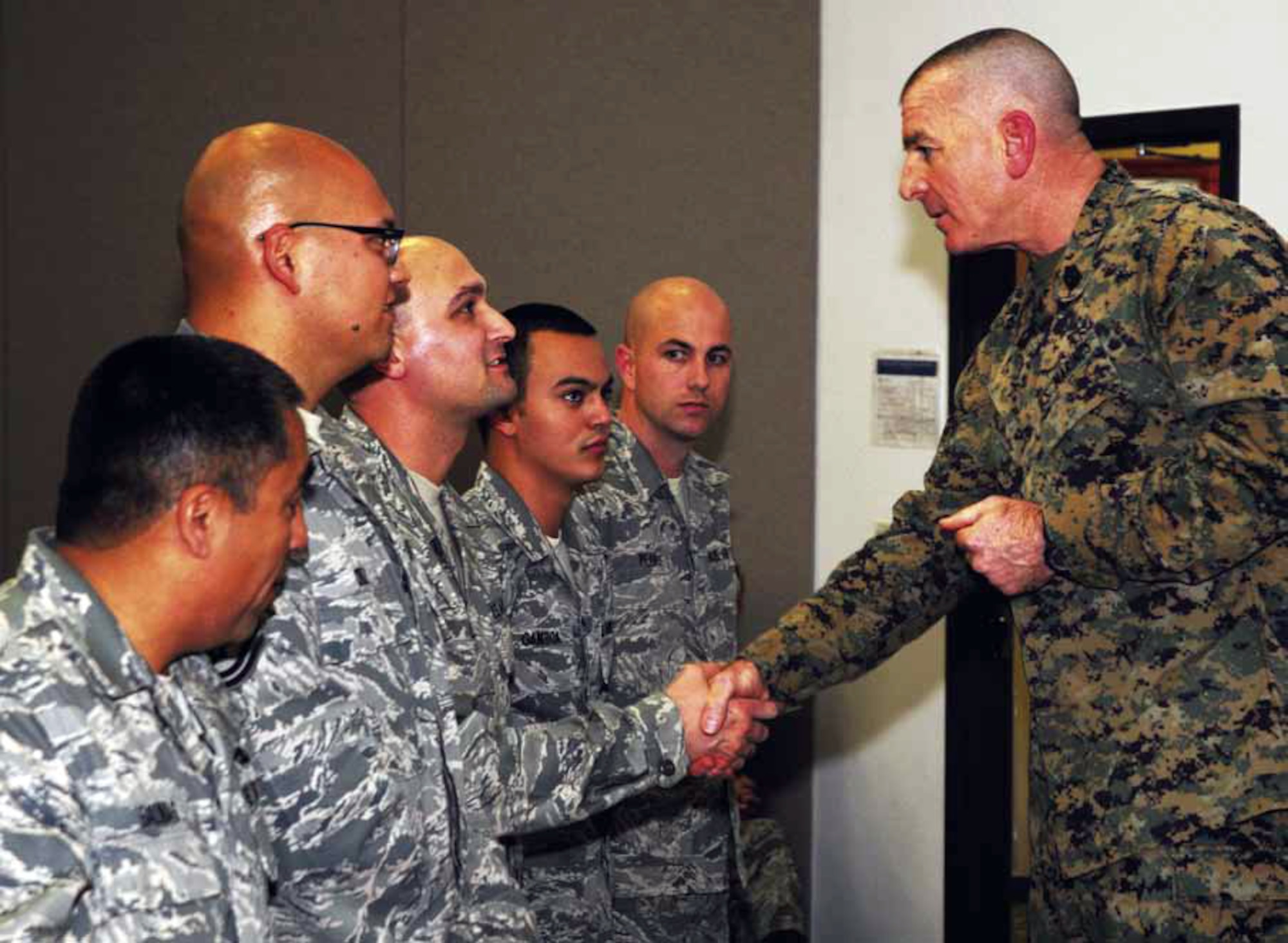 The Senior Enlisted Advisor to the Chairman, Joint Chiefs of Staff, U.S. Marine Sergeant Major Bryan Battalia, greets Airmen stationed at March Air Reserve Base, Jan. 11. The U.S. Armed Forces’ top enlisted member engaged with audience members on subjects pertaining to the CJCS’s doctrine entitled, “Vision 2020,” detailing his vision of the total military family, renewing commitment and better understanding the way forward if drastic cuts are made to the military budget. (U.S. Air National Guard photo by Staff Sgt. Mykel Anderson)