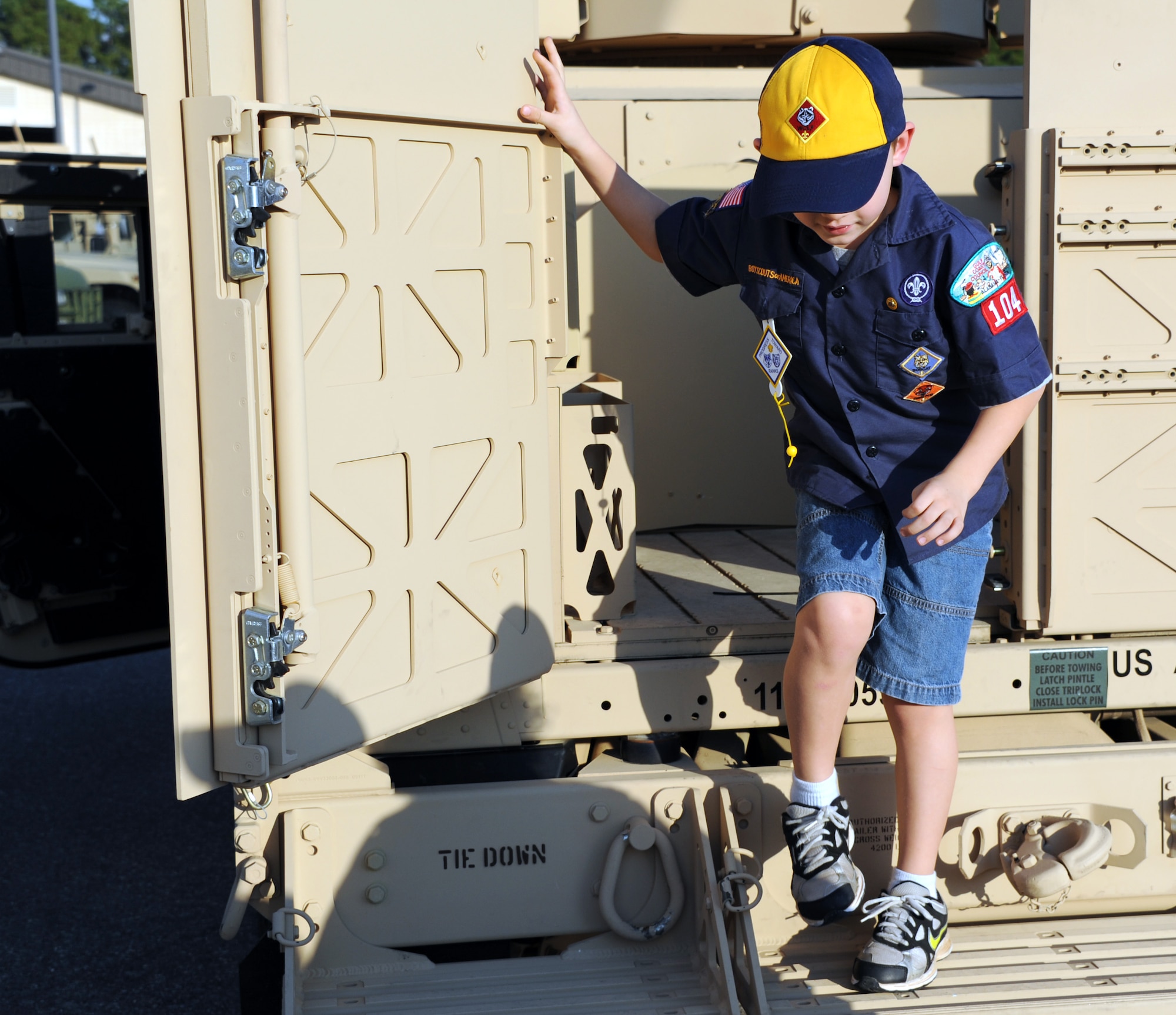 Boy Scout Andrew Polasky explores a Humvee during Cub Scout Pack 104's visit to Hurlburt Field, Fla., Jan. 24, 2013. Six Boy Scouts of America donated $760 worth of popcorn to Airmen on behalf of Pack 104 of Navarre, Fla.The Scouts were given the opportunity to explore a Humvee and witness combat controllers rappel as a token of appreciation. (U.S. Air Force photo/Rachel Arroyo)

