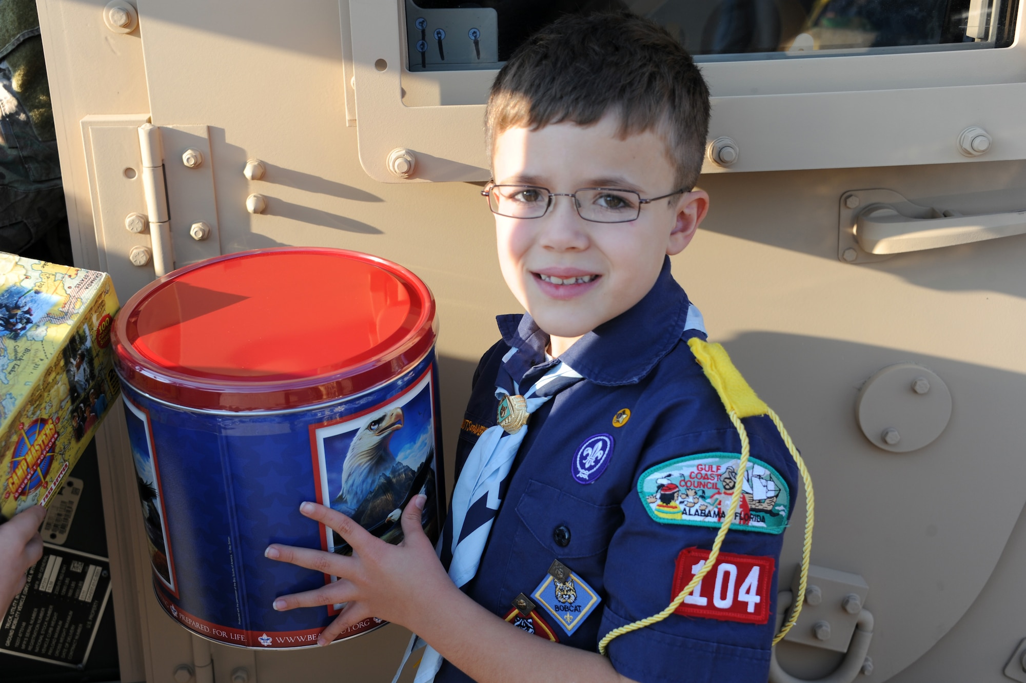 Boy Scout Maddox DeMars holds a tin of popcorn for donation during Cub Scout Pack 104's visit to Hurlburt Field, Fla., Jan. 24, 2013. Six Boy Scouts of America donated $760 worth of popcorn to Airmen on behalf of Pack 104 of Navarre, Fla. (U.S. Air Force photo/Rachel Arroyo)

