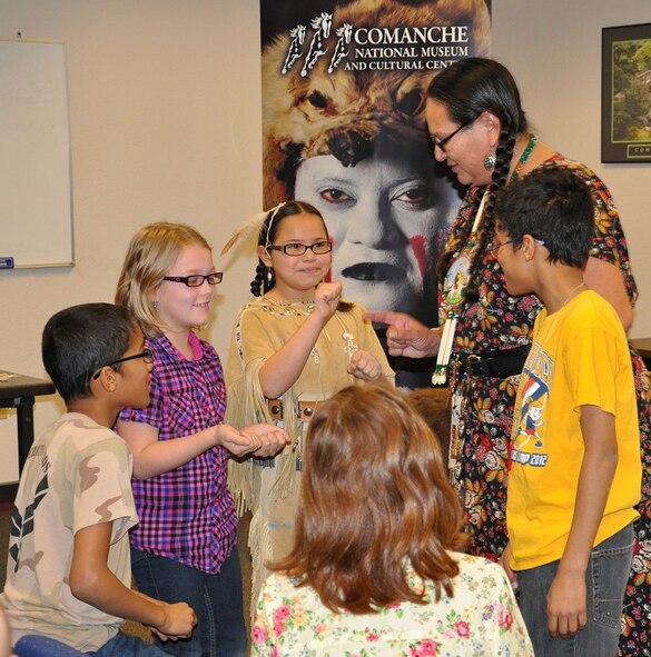 Tina Emhoolah and her granddaughter, Madison, taught Airmen and Family
Readiness Center audience members "The Hiding Game," as part of a Comanche
Tribal presentation at Sheppard Air Force Base Jan 24., 2013.  As part of a
cultural exchange, the Emhoolahs shared their tribal history, games,
artifacts and family military heritage on behalf of the Comanche Nation
Cultural Center, which  is located 50 miles north in Lawton, OKla. (U.S. Air
Force Photo/Debi Smith)
